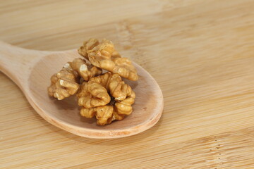 walnuts on wooden spoon