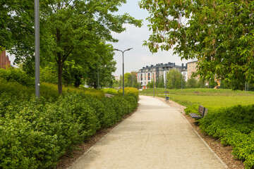 Path with bench in the garden. Poznan Poland.