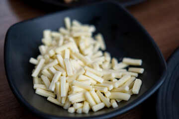 Grated cheese in a bowl, food preparation