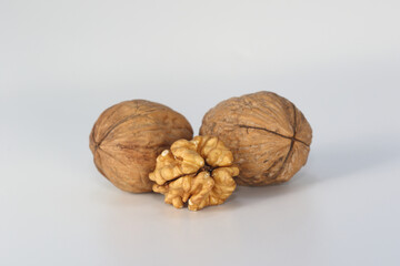 walnut kernel and whole walnuts on white background