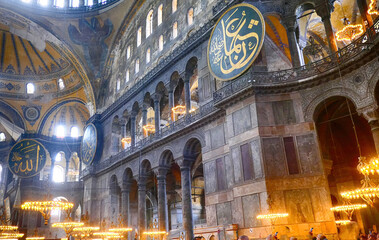 Fototapeta na wymiar Chandeliers and Corinthian coluimns of the interior of Hagia Sophia