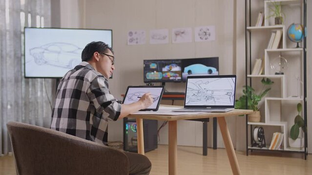 Side View Of Asian Male Having A Headache While Drawing New Car Design Concept On A Tablet In The Studio With Tv And Computers Display 3D Electric Car Model 
