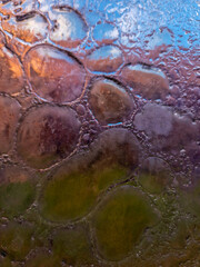 colored glass with bubbles inside. blown glass. fusing. abstract glass background