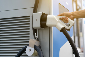 man holding electric car charger