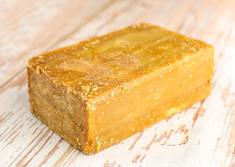 Brown household soap on wooden background