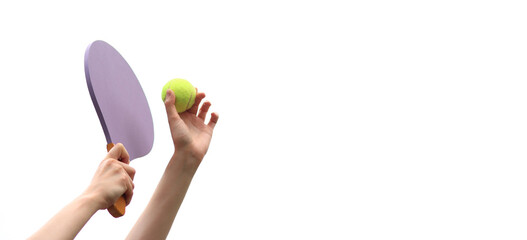 Play paddleball with a wooden racket against a gray sky. Beach tennis. A wooden paddle for playing tennis and a ball in the hands of a girl on a white background. Outdoor games