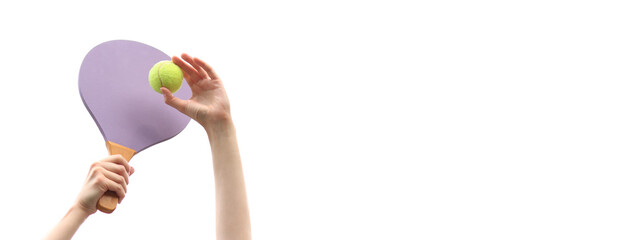 Play paddleball with a wooden racket against a gray sky. Beach tennis. A wooden paddle for playing tennis and a ball in the hands of a girl on a white background. Outdoor games