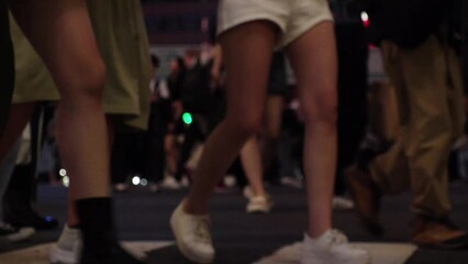 SHIBUYA, TOKYO, JAPAN : Slow motion shot of crowd of people walking at Shibuya crossing at night. Busy downtown area in Tokyo. Japanese people, urban city nightlife and metropolis concept video.