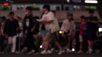 SHIBUYA, TOKYO, JAPAN : Slow motion shot of crowd of people walking at Shibuya crossing at night. Busy downtown area in Tokyo. Japanese people, urban city nightlife and metropolis concept video.