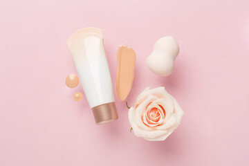 Composition with makeup foundation on color background, top view