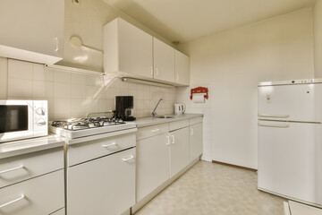 a kitchen area with white cabinets and appliances on the counter top in front of the refrigerator, oven, microwave and dishwasher