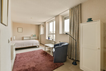 a hotel room with a bed, desk and chair in front of the window looking out into the bedroom area
