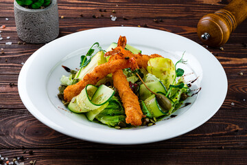 Fresh tempura shrimp fried breaded with a salad of cucumbers, lettuce, capers, apples and pumpkin seeds.