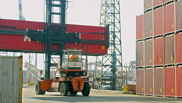 4K footage of moving forklift carrying container at port stock video. 
