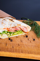 Delicious kebab with meat, lettuce, tomato, onion and sauce with french fries.