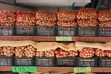 Street stall selling potatoes to make wrinkles in Tenerife and on the top shelf many mayas of country nuts.