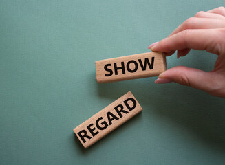 Show regard symbol. Wooden blocks with words Show regard. Beautiful grey green background. Businessman hand. Business and Show regard concept. Copy space.