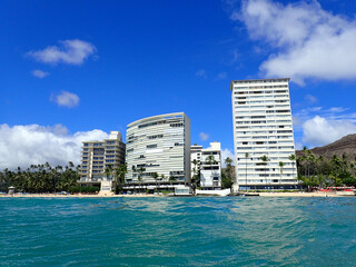 Wavy Water on Ocean off Kaimana Beach with Hotels and Condos on Oahu, Hawaii