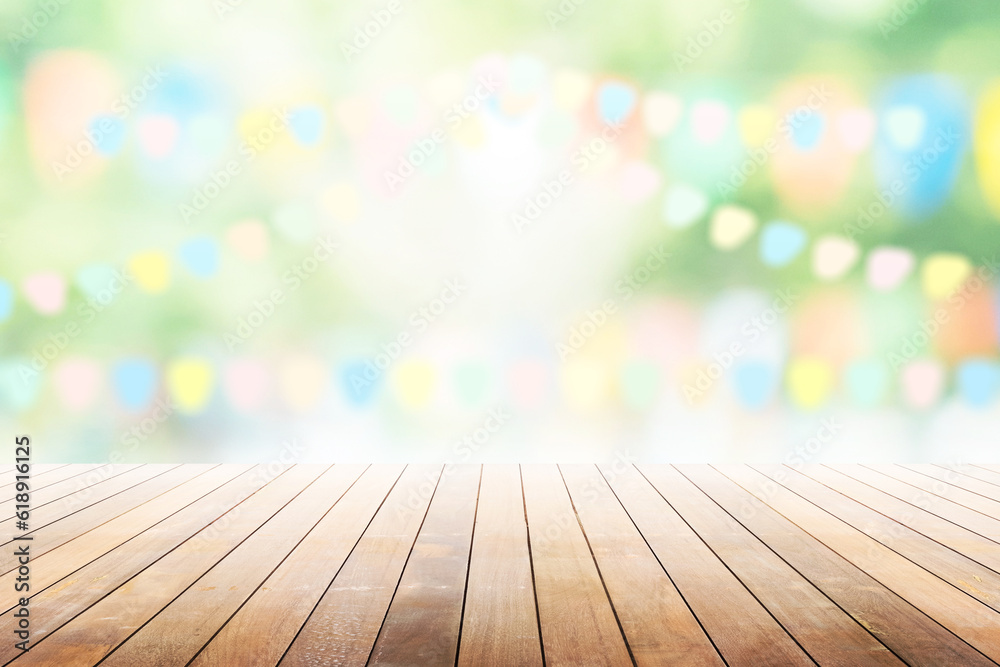 Wall mural empty wooden table with party in garden background blurred.