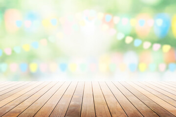 Empty wooden table with party in garden background blurred.