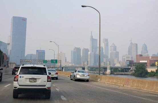 Philadelphia, Pennsylvania, U.S - June 29, 2023 - Traffic on I-95 North with the foggy view of the city due to the smoke of Canadian forest fire