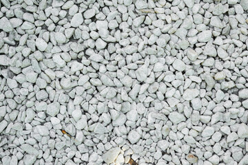 Clean white pebble texture. Small stones on the ground. Top view of colorful natural gravel on the summer beach