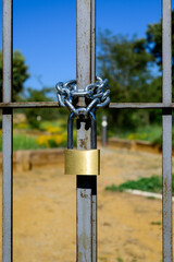 Old Locked Padlock Hanging On The Old Fashioned Metal Gate