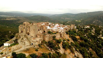 Obraz premium aerial view of Castillo de Castellar, medieval town within a castle in Andalusia at a cloudy day, Castellar de la Frontera, province of Cádiz, Spain