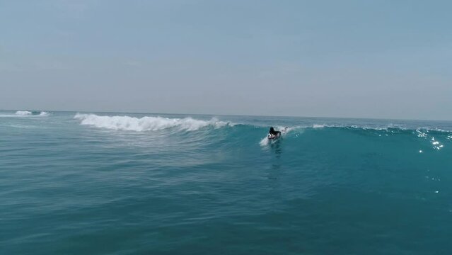 Surfing in Asia side. Powerful ocean and one man alone do workout with surf barreled at big waves. Beautiful beachscape