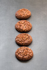 Cocoa oatmeal cookies with crushed peanuts. Dark gray background