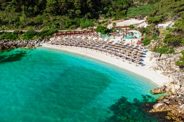 Fototapeta na wymiar Beach with turquoise sea and umbrellas. Marble Beach, Thassos, Greece