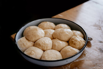 Bread dough balls that has rised at the second fermentation stage or proofing, on a baking sheet, in the bread making process.
