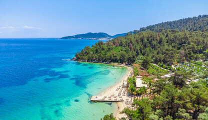 Beach and turquoise sea, palm trees. La Scala Beach, Thassos, Greece