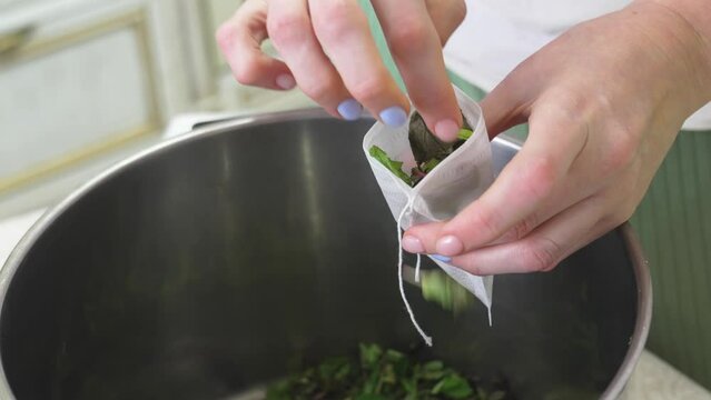 The process of packing the collection of tea herbs in convenient portioned bags.