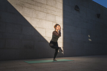 Fototapeta na wymiar One adult caucasian woman doing yoga practice in summer day outdoor