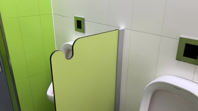 Rows of modern urinals with a sensor WC flush in a public men's room