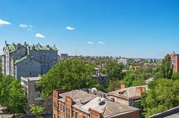 Obraz premium View of roofs of urban highrise buildings and cottages