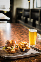 Burger with fries and a beer on a table