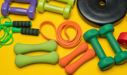 colored fitness background with fitness accessories