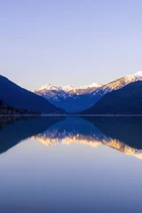 Fotobehang Calm lake with a reflection of a mountain landscape © Martin