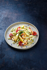 Weißer Spargel glasiert mit gebratenen Riesengarnelen und Pistazien Pasta serviert als close-up auf einem Design Teller mit Textfreiraum