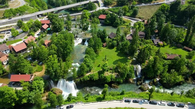 Aerial shot drone flies to right high in wide shot over Rastoke, Slunj, Croatia