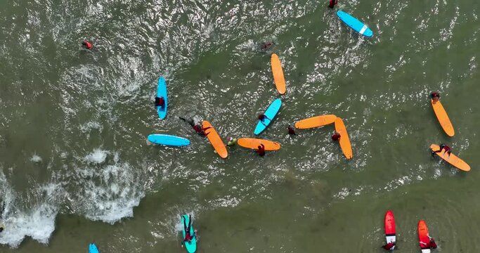 Top view of the beach with surfers waiting for a wave 4k