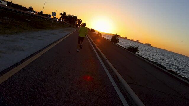 POV sunrise woman jogger running positive energy Florida
