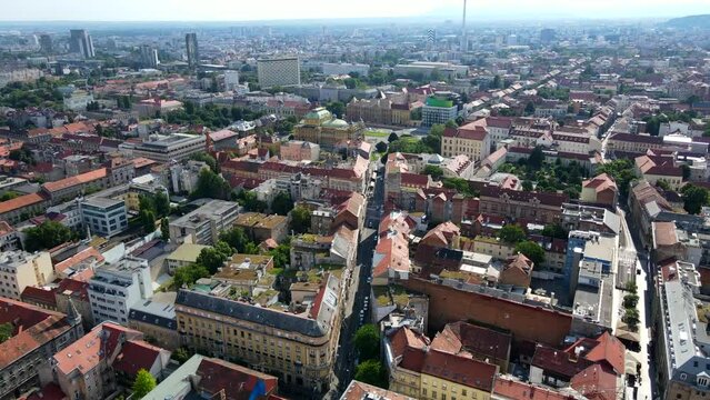 Aerial shot drone flies toward Park Zrinjevac from Trg bana Josipa Jelačića in Zagreb, Croatia