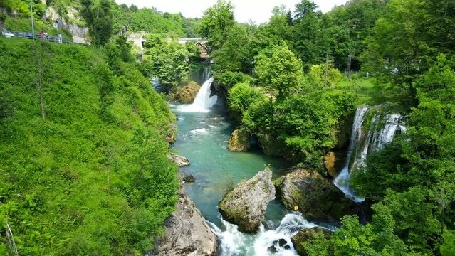 Aerial shot drone flies low along river with waterfalls in Rastoke, Slunj, Croatia