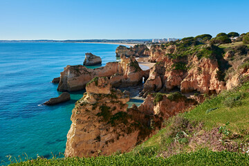 Spectacular view of Alvor village and colorful limestone rocks. Trekking route from Portimao to Alvor, Portugal