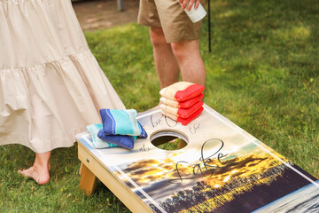 people playing cornhole, a popular American sport, representing camaraderie, outdoor leisure, competition, and the spirit of friendly gatherings
