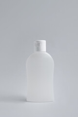 Bottle of cosmetic product on light grey background
