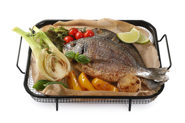 Delicious roasted dorado fish with vegetables, herbs and lime isolated on white, above view